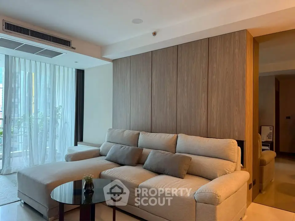 Spacious modern living room with elegant sofa and floor-to-ceiling windows