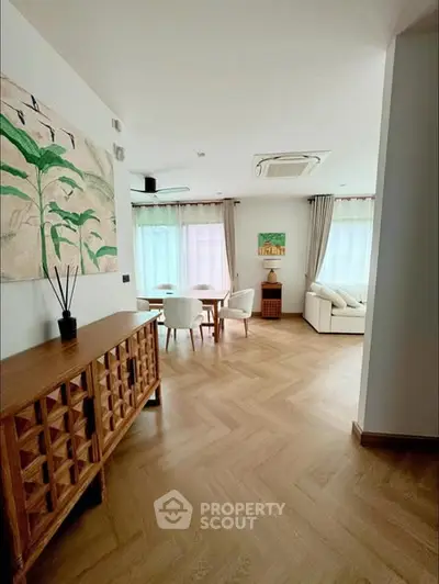 Spacious living room with elegant wooden furniture and natural light