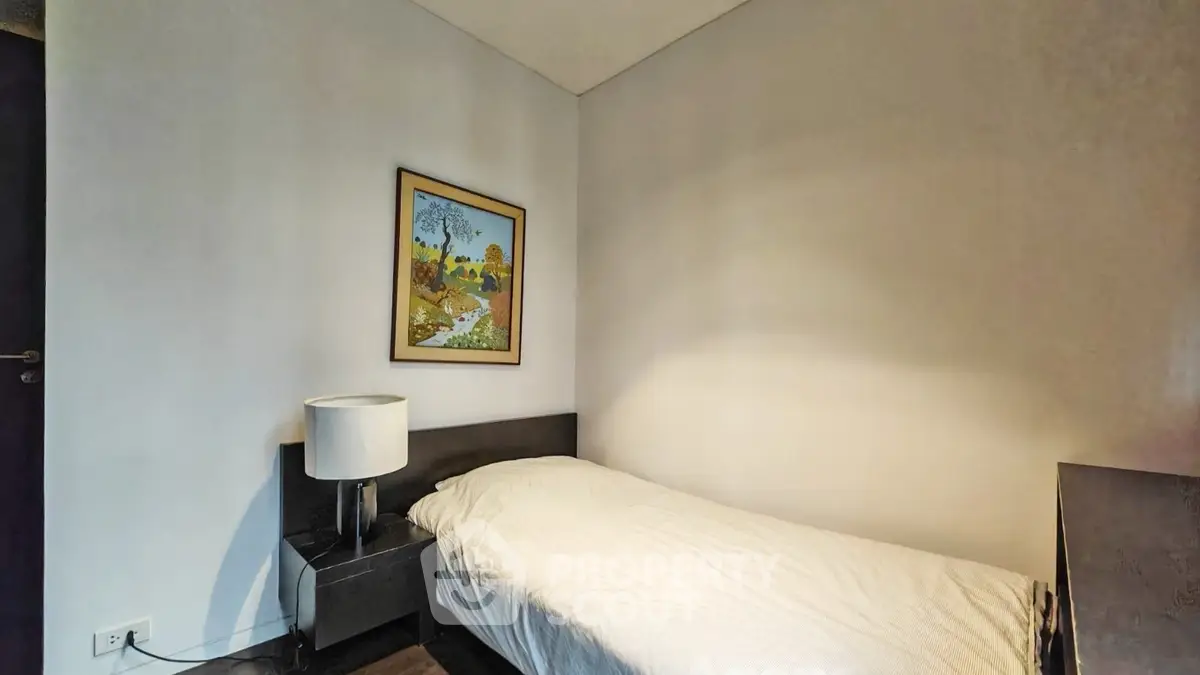 Cozy bedroom with modern decor and single bed, perfect for minimalist living.