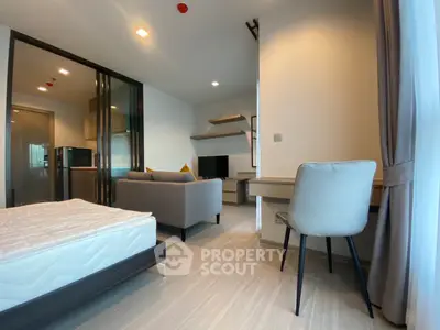 Modern studio apartment with open layout, featuring a cozy living area and workspace.