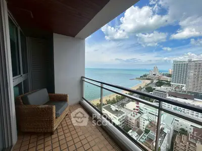 Stunning high-rise balcony with breathtaking ocean view and cozy seating area.