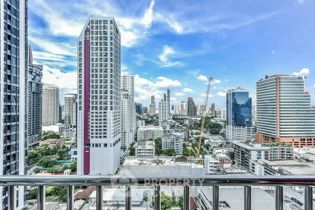 Stunning cityscape view from a high-rise balcony in a vibrant urban setting.