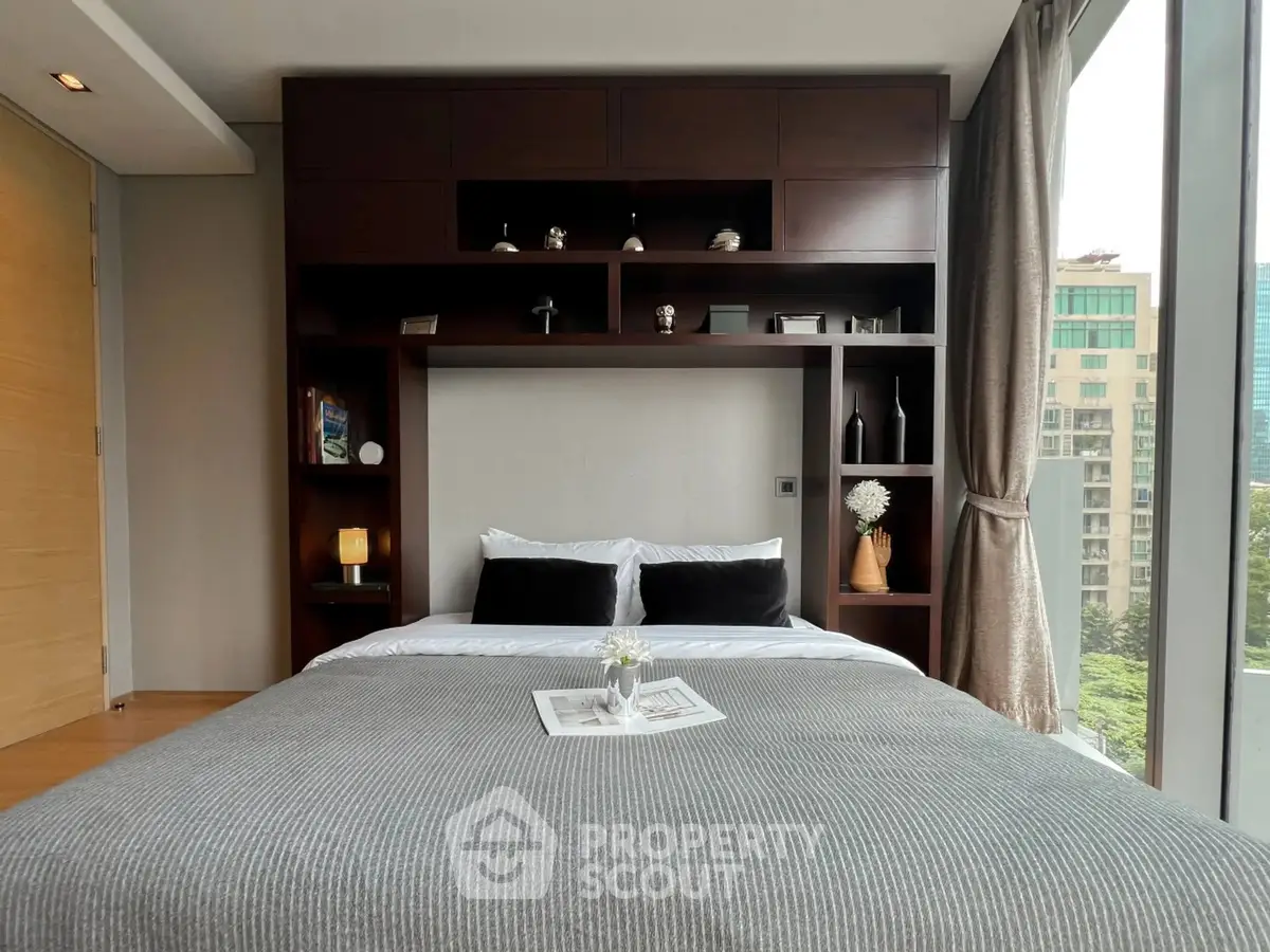 Modern bedroom with large window and stylish shelving unit