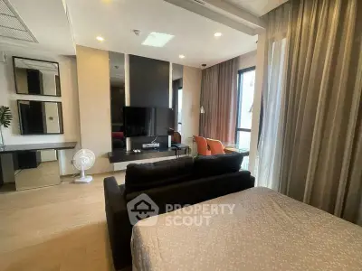 Modern living room with stylish decor and large windows in a cozy apartment.