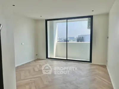 Spacious modern room with large window and city view