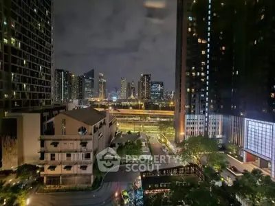 Stunning night view of urban skyline from high-rise apartment, showcasing city lights and modern architecture.