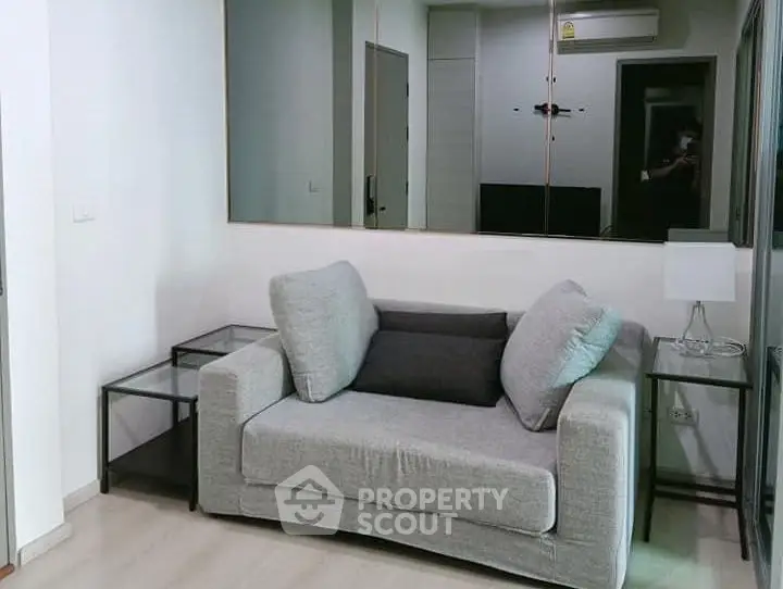 Modern living room with stylish gray sofa and sleek side tables