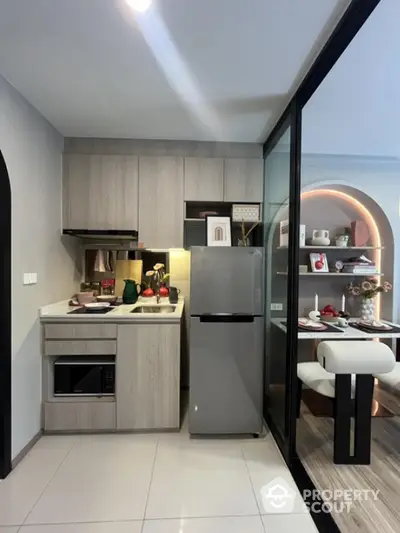 Modern compact kitchen with sleek appliances and stylish dining area