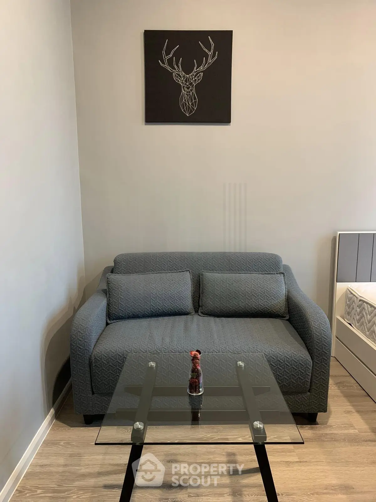 Cozy living room with modern sofa and glass coffee table, perfect for relaxation.