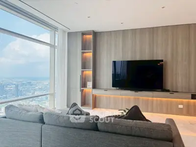 Luxurious living room with panoramic city view and modern entertainment setup.