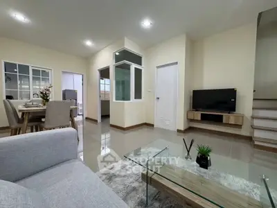 Spacious modern living room with open dining area and sleek decor