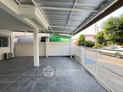 Spacious covered outdoor area with tiled flooring and modern design.