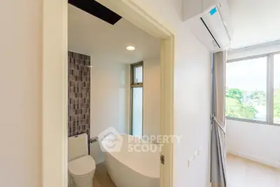 Modern bathroom with freestanding bathtub and natural light