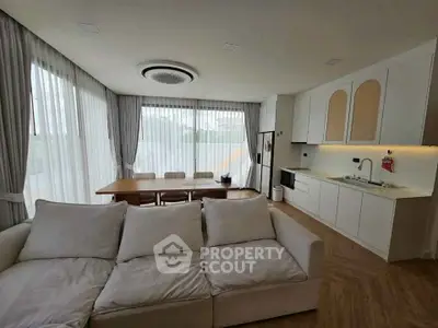 Spacious modern living room with open kitchen and large windows