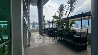 Spacious balcony with city view and modern seating area