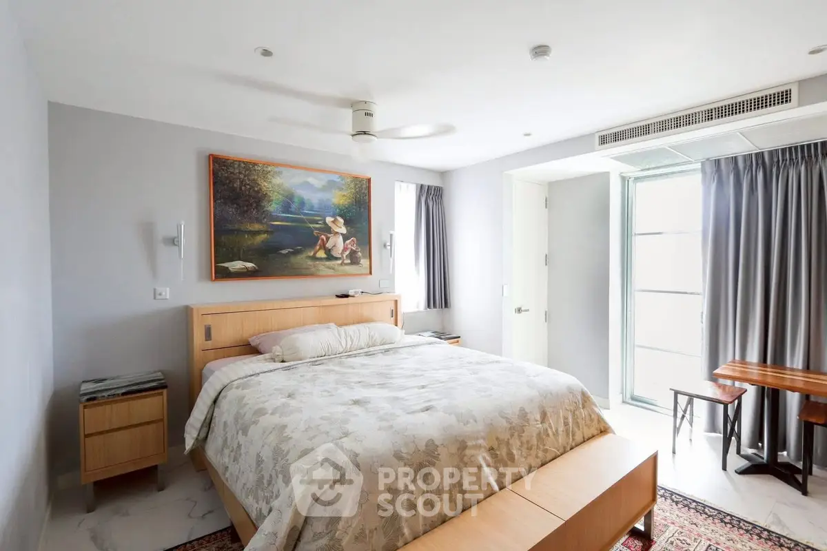 Spacious bedroom with modern decor and natural light