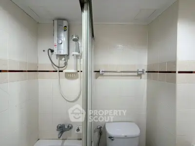 Compact bathroom with shower and toilet in modern apartment