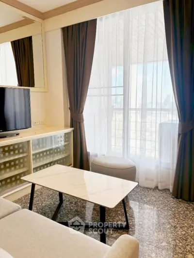 Chic living room with modern decor, large window, and city view, perfect for urban living.