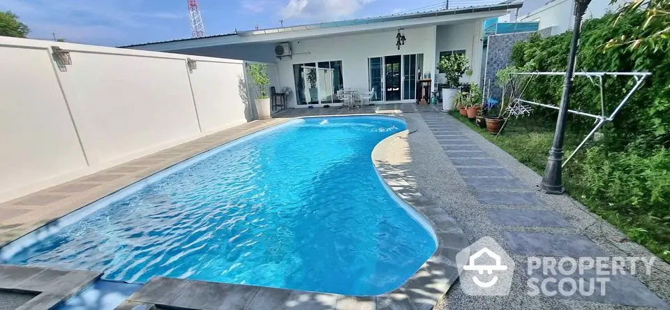 Stunning private pool with modern patio in luxurious backyard setting