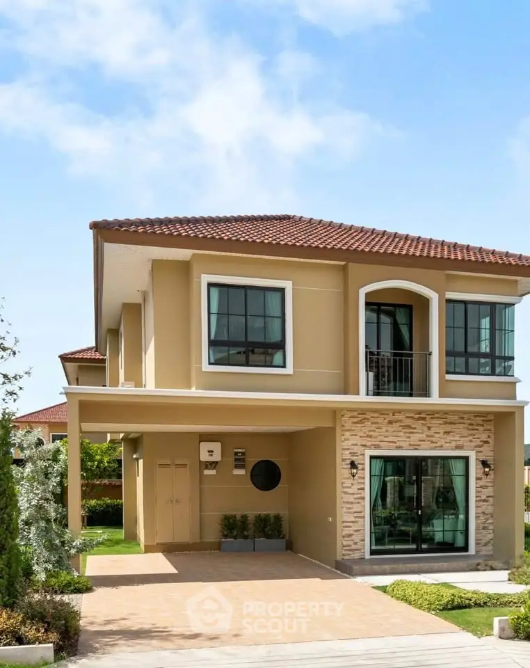 Elegant two-story house with modern design and spacious driveway in a serene neighborhood.