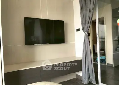 Modern living room with wall-mounted TV and elegant curtain divider