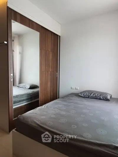 Modern bedroom with sleek wardrobe and cozy bed in a stylish apartment.