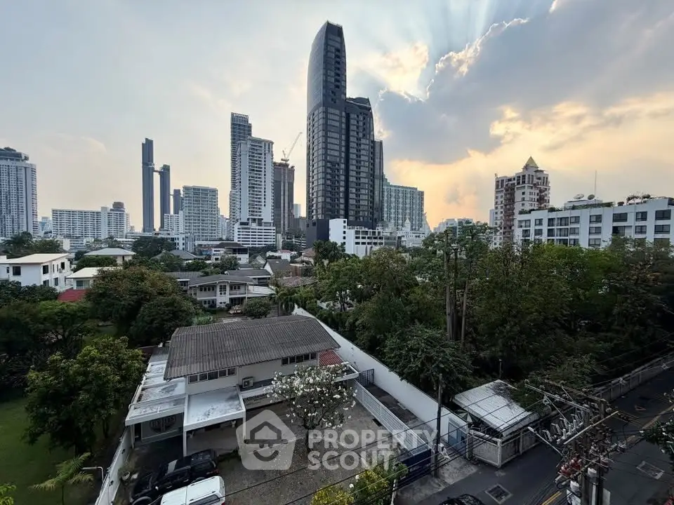 Stunning cityscape view with modern high-rise buildings and lush greenery, perfect for urban living.