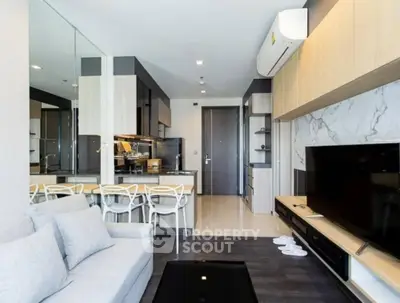 Modern living room with open kitchen layout and sleek design