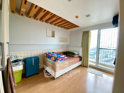 Bright bedroom with wooden ceiling and large window offering city view