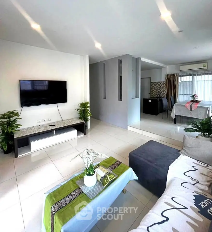 Spacious modern living room with TV and stylish decor