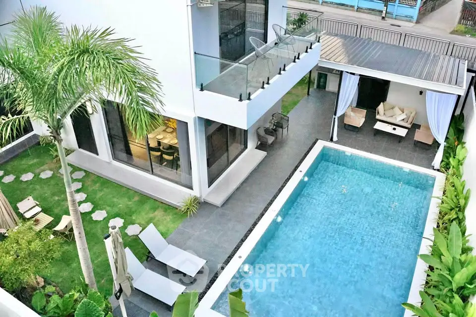 Luxurious modern villa with private pool and lush garden, perfect for relaxation and entertainment.