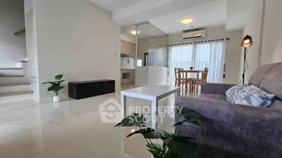 Spacious modern living room with open layout and stylish decor, perfect for comfortable living.