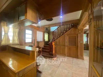 Spacious wooden interior with elegant staircase and open kitchen layout