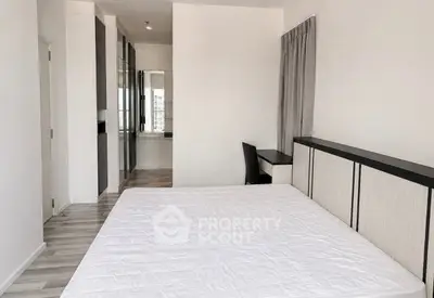 Spacious modern bedroom with sleek design and ample natural light