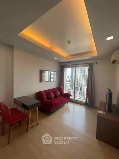 Modern living room with red sofa and city view balcony