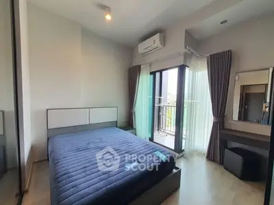 Modern bedroom with balcony access and stylish decor in a high-rise apartment.
