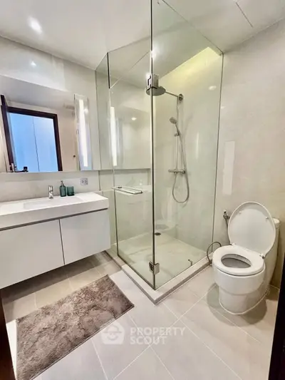 Modern bathroom with glass shower and sleek fixtures