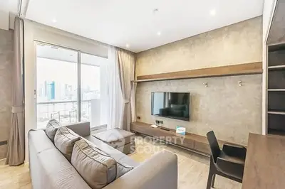 Modern living room with sleek furniture and city view balcony in luxury apartment.