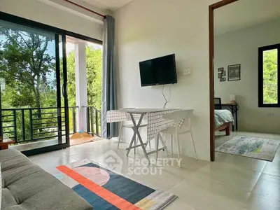 Modern living room with balcony view and adjacent bedroom in stylish apartment