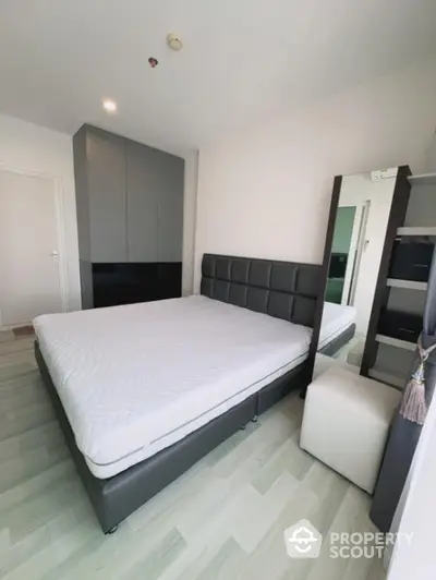 Spacious bedroom with modern king-sized bed, large wardrobe, and elegant flooring, perfect for restful nights and stylish living.