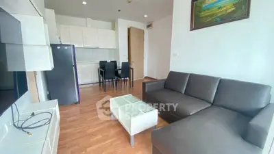 Modern living room with sleek furniture and open kitchen layout