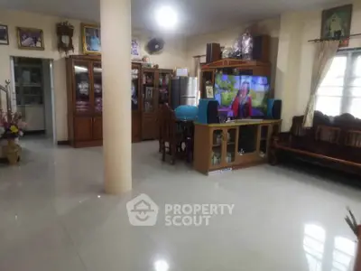 Spacious living room with elegant wooden furniture and modern entertainment center