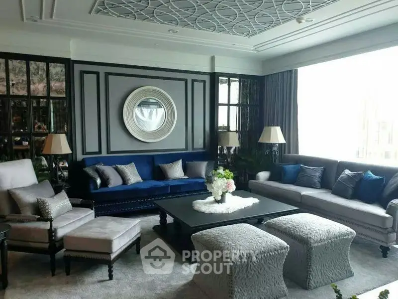 Luxurious living room with elegant decor and plush seating in a modern apartment.