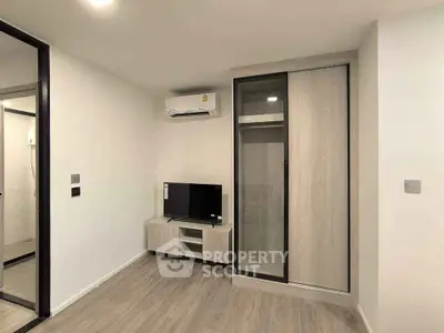 Modern minimalist living room with TV and air conditioning in stylish apartment