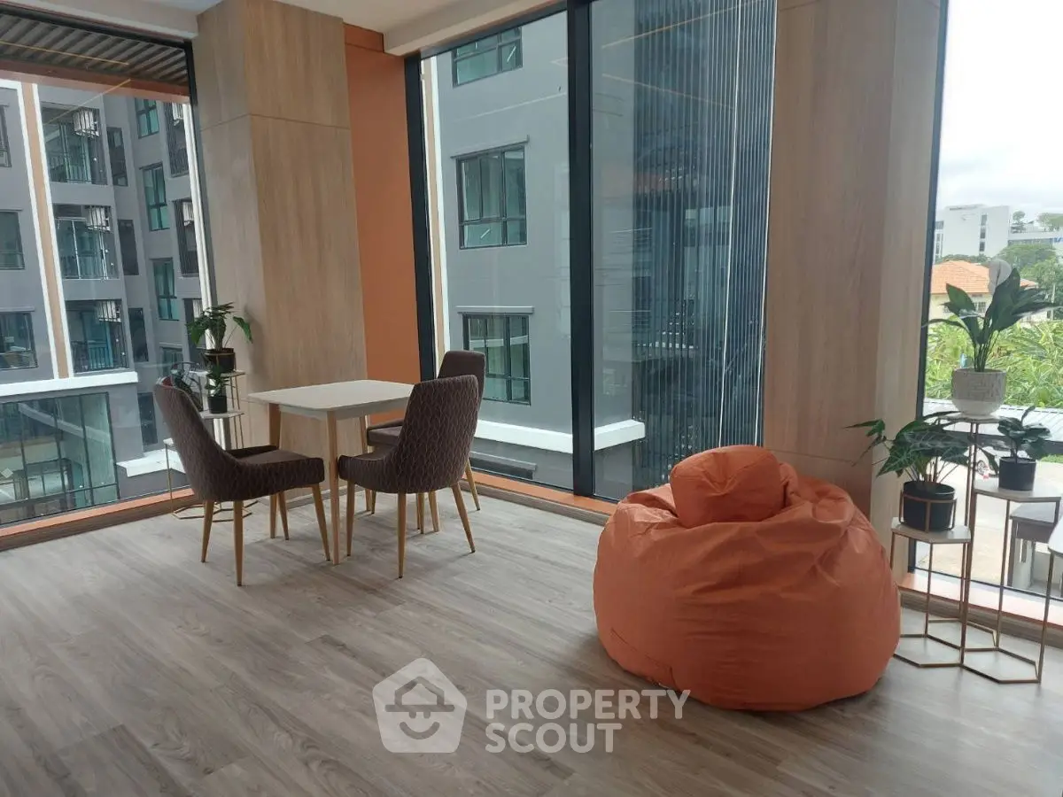 Modern apartment interior with large windows and stylish furniture