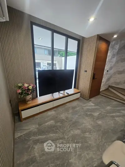 Modern living room with large window and stylish decor