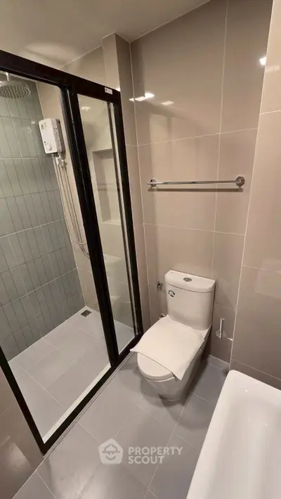 Modern bathroom with sleek shower and toilet in contemporary apartment