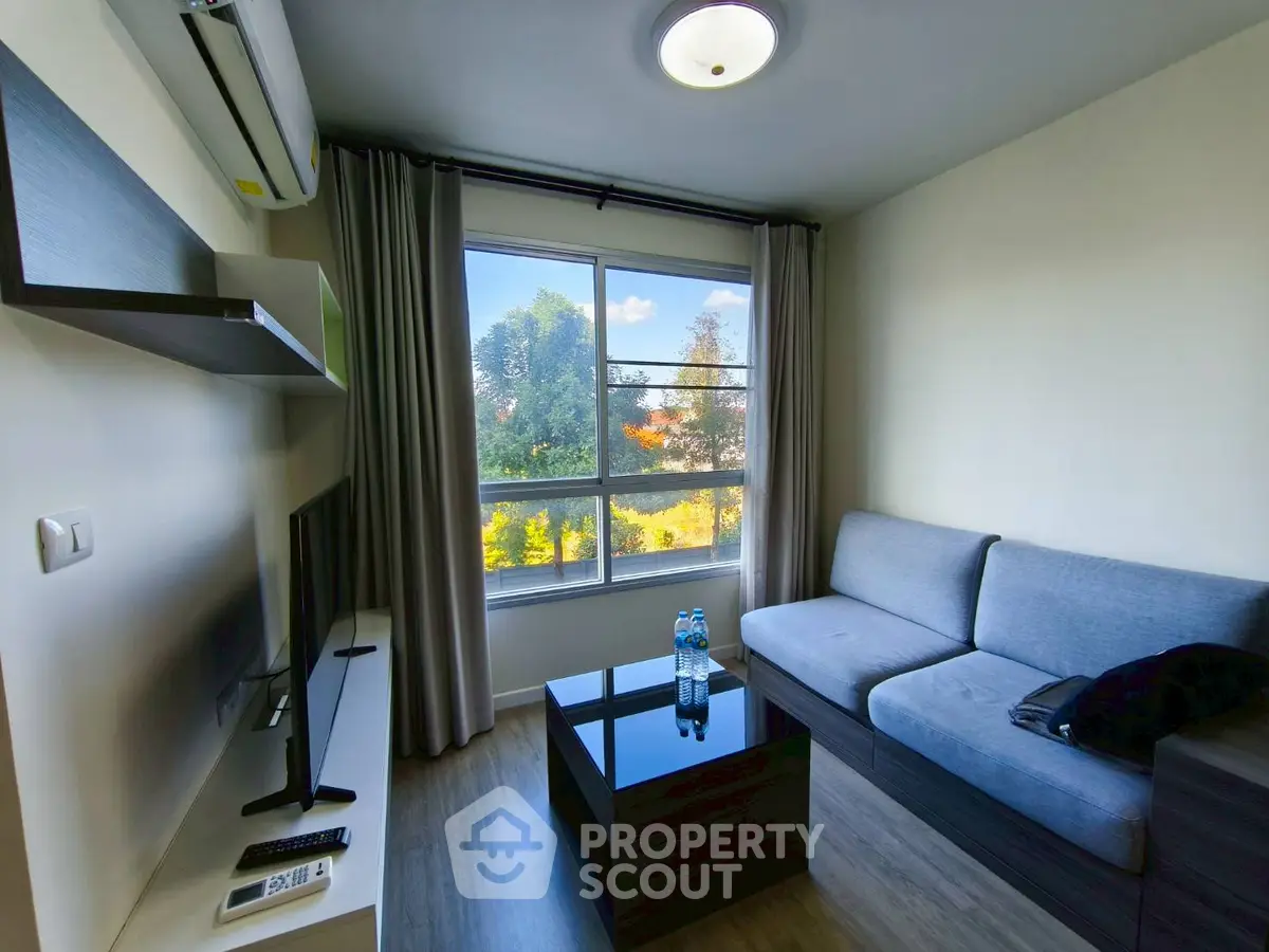 Modern living room with large window and stylish furniture