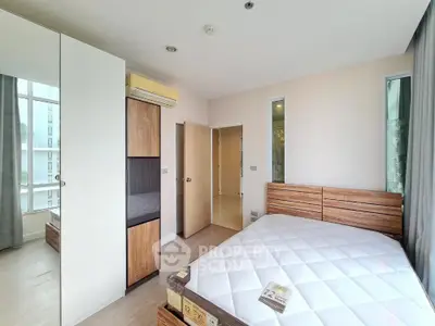 Modern bedroom with wooden furniture and large windows in a bright apartment