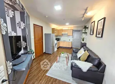 Stylish living room with modern kitchen, cozy seating, and elegant decor in open layout apartment.